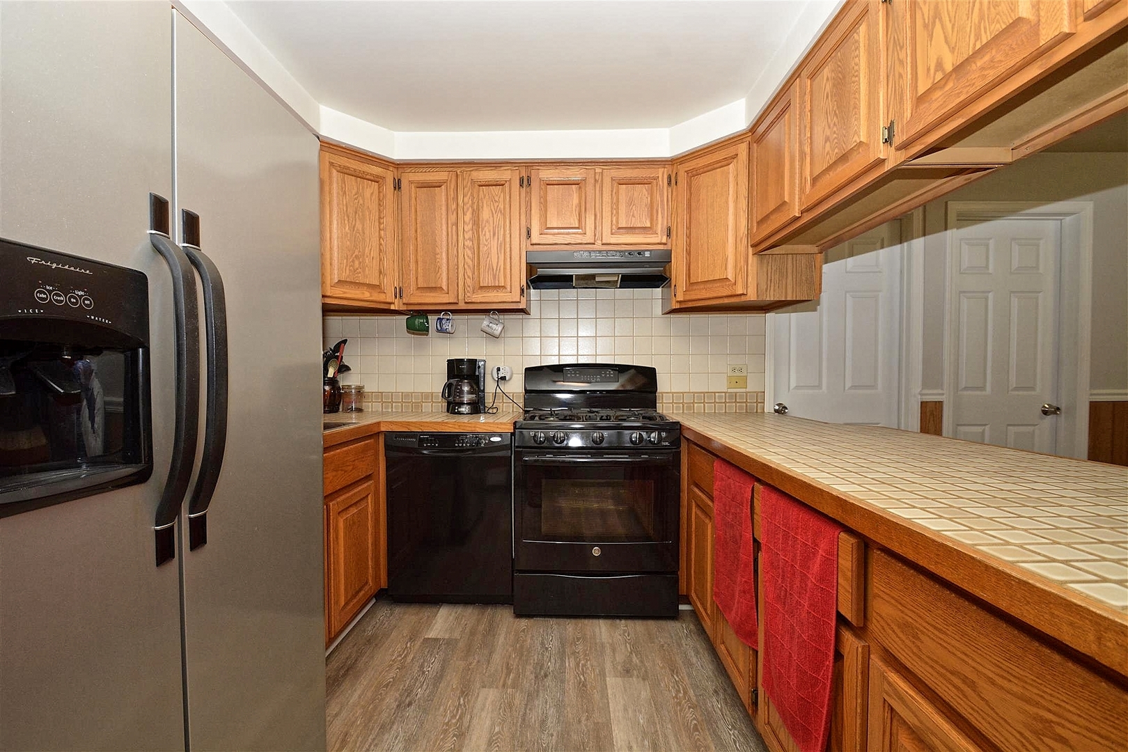 6138 Birmingham Street Chicago Ridge, IL 60415 - Photo 5 of 26 a kitchen with stainless steel appliances granite countertop a refrigerator a sink dishwasher a stove top oven a refrigerator and cabinets