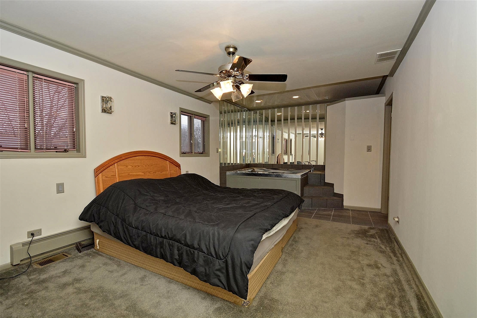 6138 Birmingham Street Chicago Ridge, IL 60415 - Photo 9 of 26 a spacious bedroom with a bed and a chandelier