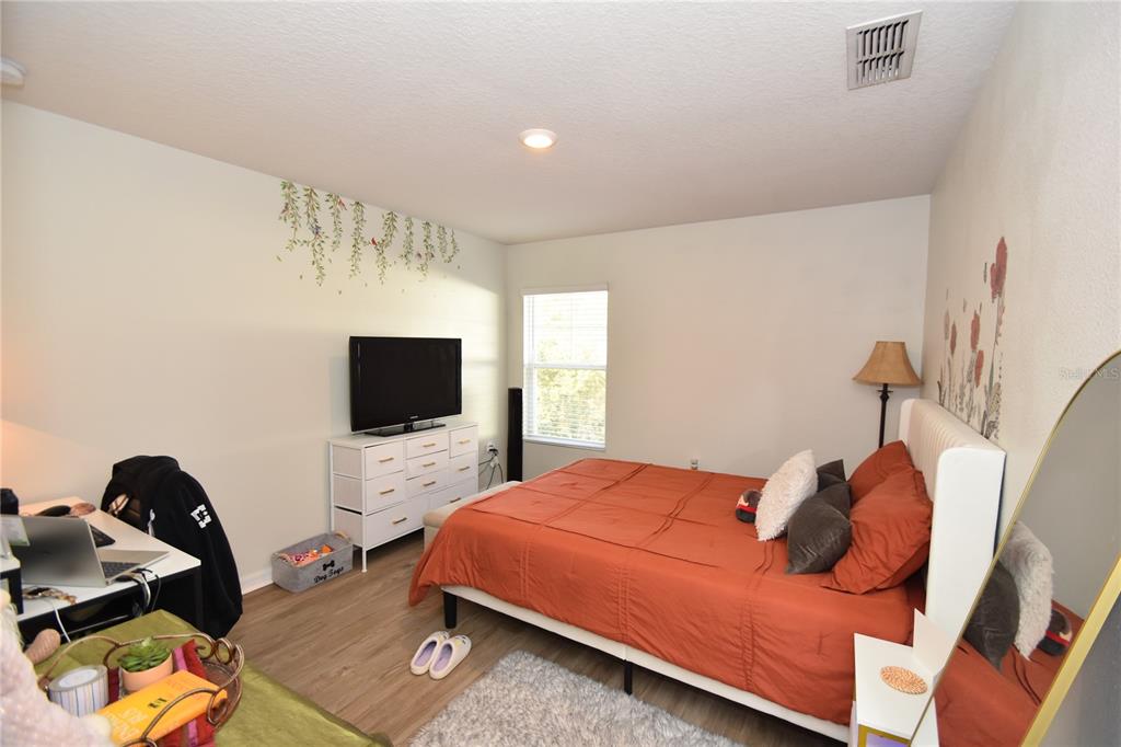 5 Rainstone Lane Palm Coast, FL 32164 - Photo 13 of 33 a bedroom with a bed and a flat screen tv