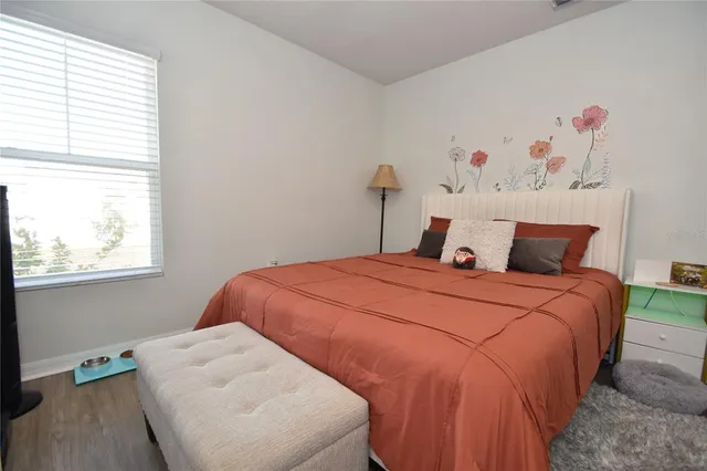 a bedroom with a bed and a window