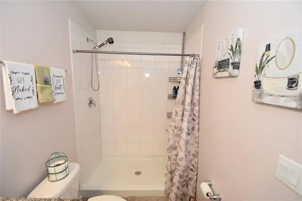 a bathroom with a shower a toilet and sink