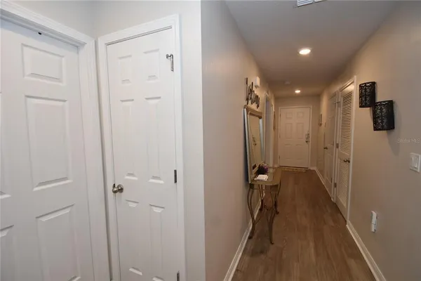 a view of a hallway with wooden floor