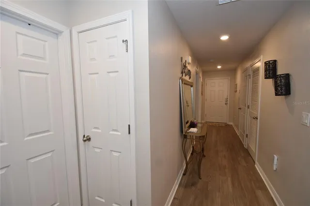 a view of a hallway with wooden floor
