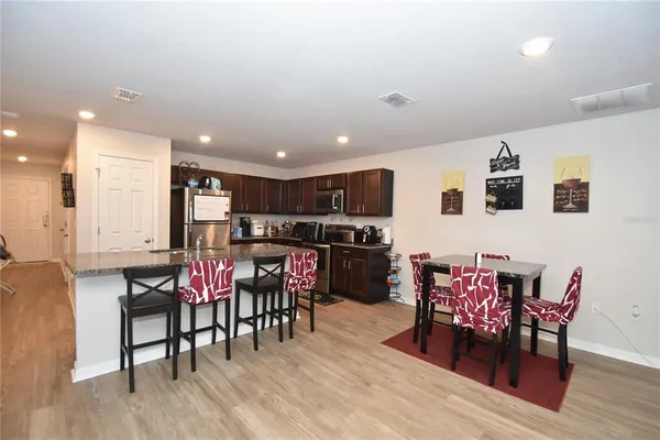 a view of a dining room with furniture and wooden floor