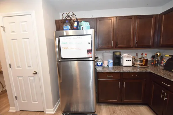 a kitchen with a refrigerator and cabinets