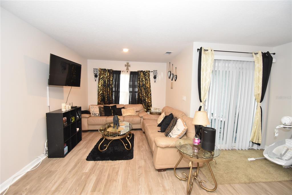 5 Rainstone Lane Palm Coast, FL 32164 - Photo 28 of 33 a living room with furniture and a flat screen tv