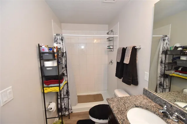 a bathroom with a sink toilet and shower