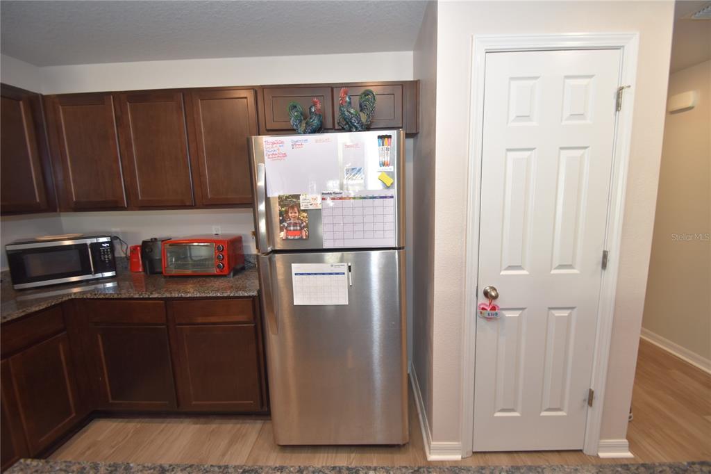 5 Rainstone Lane Palm Coast, FL 32164 - Photo 6 of 33 a kitchen with a refrigerator and cabinets