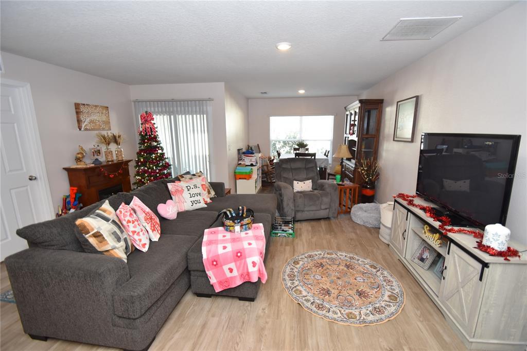 5 Rainstone Lane Palm Coast, FL 32164 - Photo 9 of 33 a living room with furniture and a flat screen tv