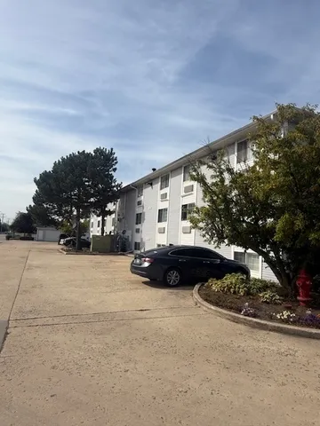 a view of a house with a yard and tree s
