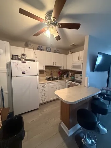 a kitchen with a sink a stove and chairs