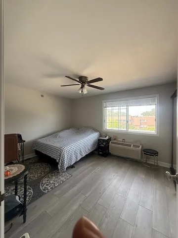 a bedroom with a bed and a window