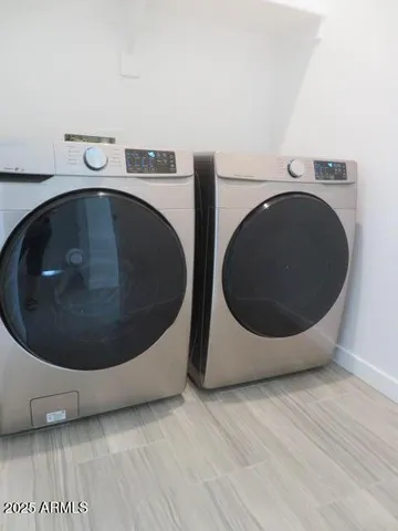 a utility room with washing machine and dryer