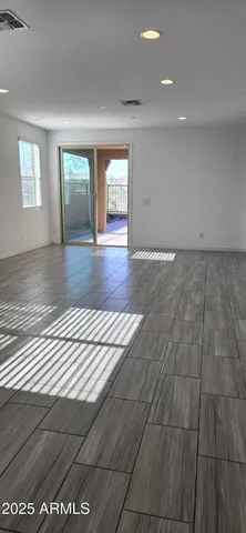 a view of wooden floor and windows in a room