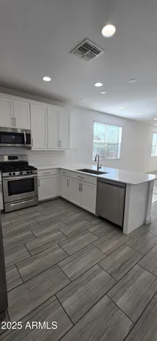 a kitchen with stainless steel appliances granite countertop a sink and cabinets