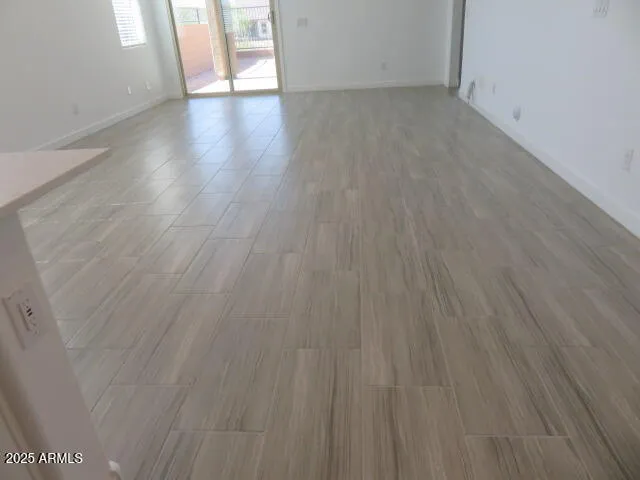 a view of a room with wooden floor and windows