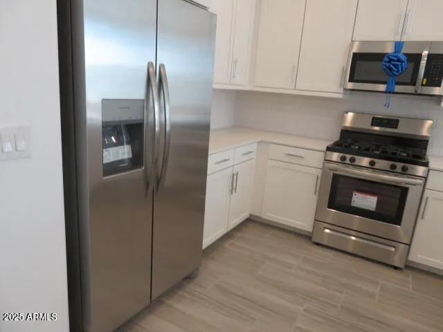 a kitchen with a stove and a refrigerator
