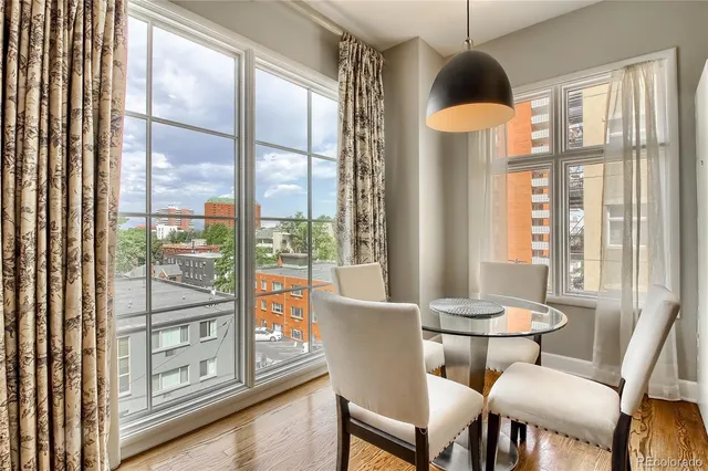 a view of a dining room with furniture window and wooden floor