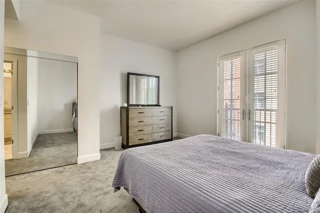 a bedroom with a bed and a cabinets