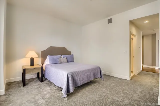 a bedroom with a bed and a lamp on table