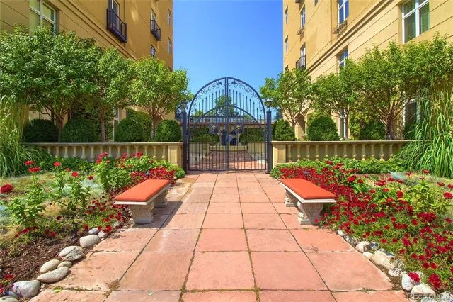 a view of a pathway with a wrought fence