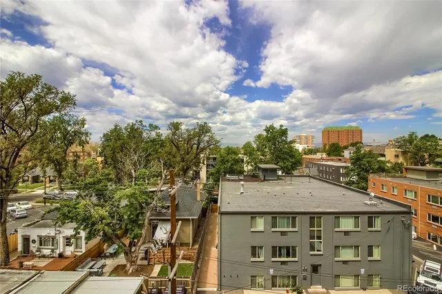 a view of a white building among the street