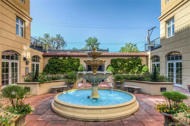 a view of a house with a fountain back yard