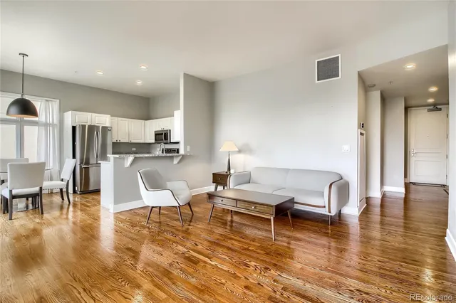 a living room with fireplace furniture and a wooden floor