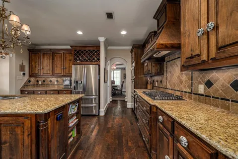 a kitchen with a stove a sink and a refrigerator