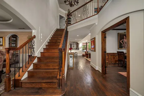 a view of entryway and hall with wooden floor