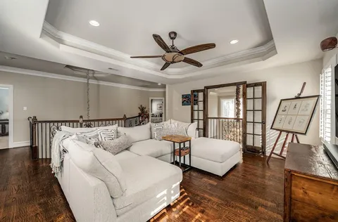 a living room with furniture and a wooden floor