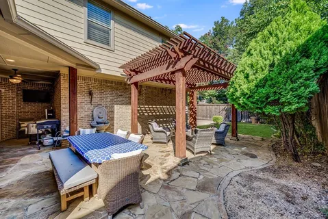 a roof deck with table and chairs under an umbrella