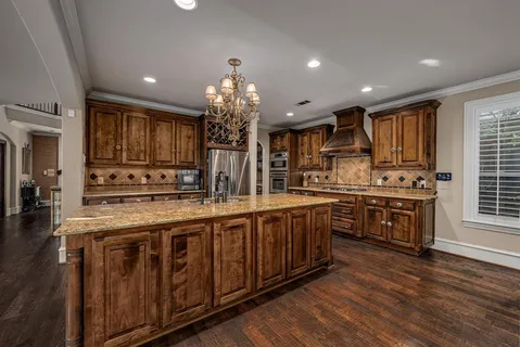 a open kitchen with stainless steel appliances granite countertop a stove and cabinets