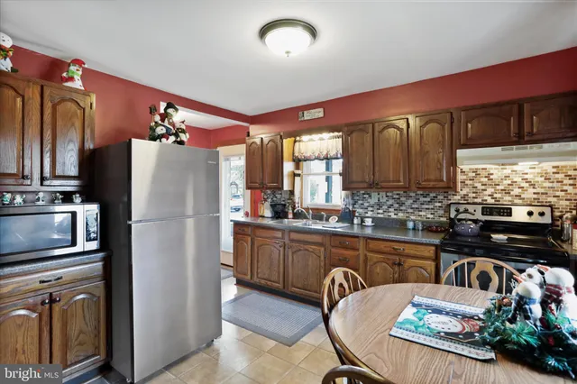 a kitchen with refrigerator and cabinets
