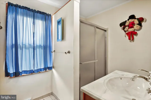 a bathroom with a sink vanity and a mirror