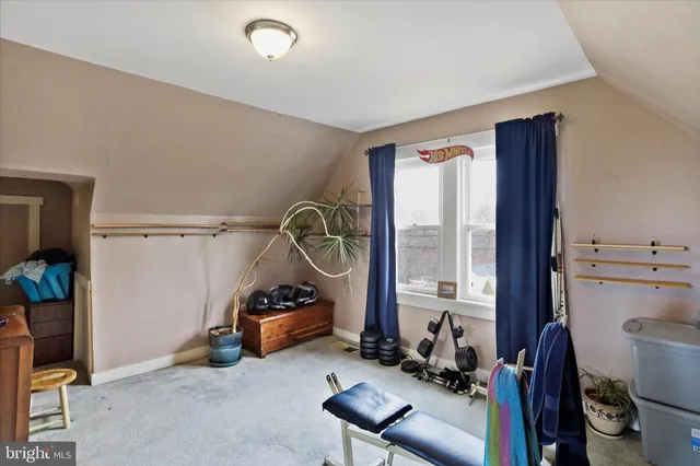 a room with gym equipment and a large window