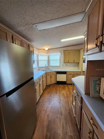 a kitchen with stainless steel appliances granite countertop a stove and a refrigerator
