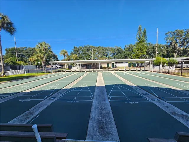 a kitchen with kitchen island granite countertop a sink stove top oven and refrigerator