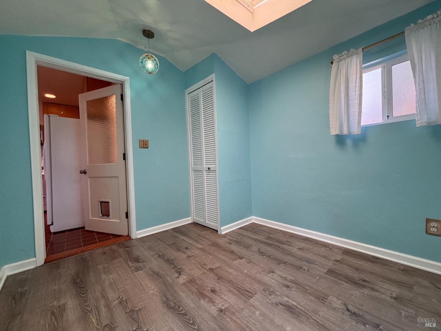 71 Rocca Drive Fairfax, CA 94930 - Photo 11 of 17 an empty room with wooden floor and windows