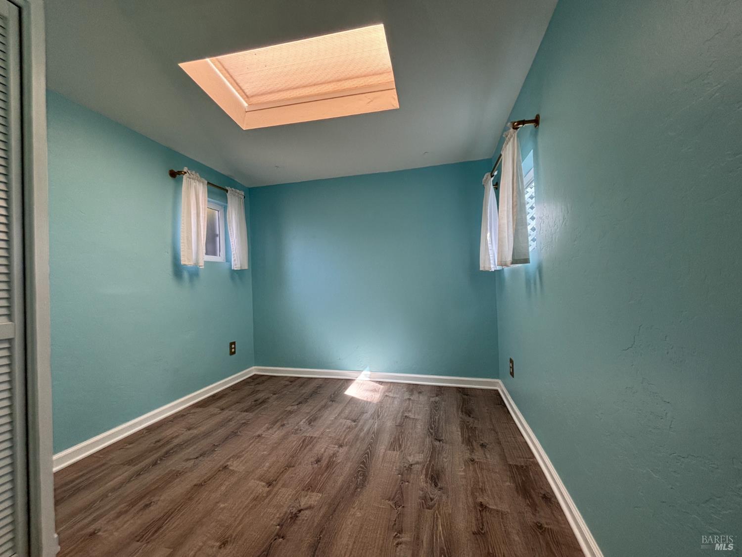 71 Rocca Drive Fairfax, CA 94930 - Photo 10 of 17 an empty room with wooden floor and windows