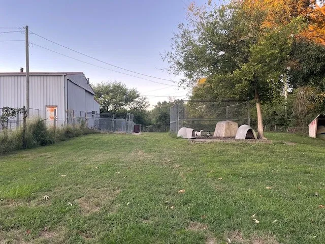 a backyard of a house with table and chairs