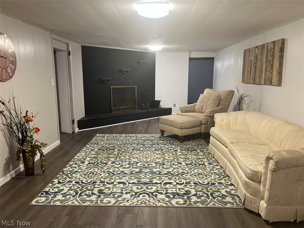 759 Truesdale Road Youngstown, OH 44511 - Photo 25 of 37 Living room featuring a fireplace,dark hardwood / wood-style floors