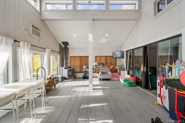 a living room with lots of furniture and a large window