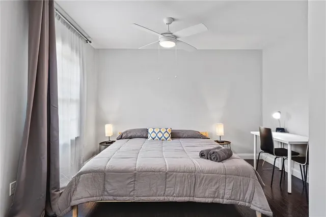 a bedroom with a bed and wooden floor