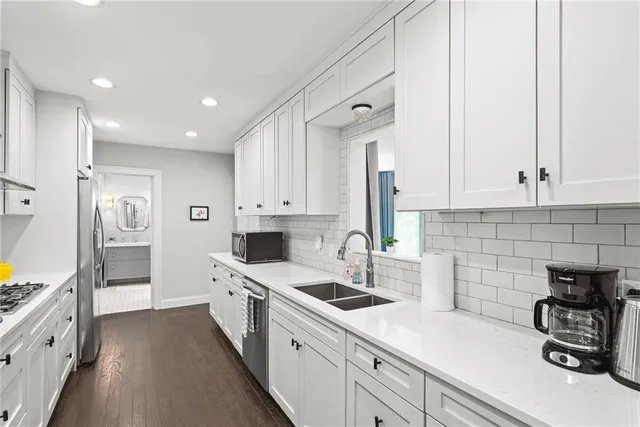 a kitchen with stainless steel appliances cabinets and a refrigerator