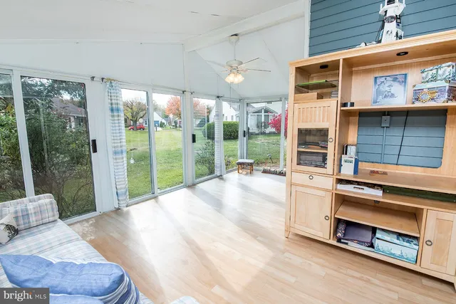 a view of a living room and entry way to room with wooden floor