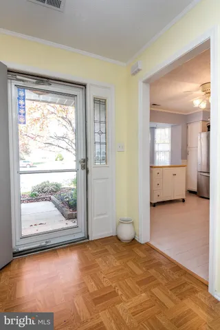 a view of a big room with wooden floor and windows