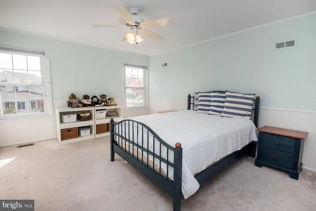 a bathroom with a toilet sink vanity and mirror