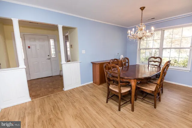 a dining room with furniture window and wooden floor