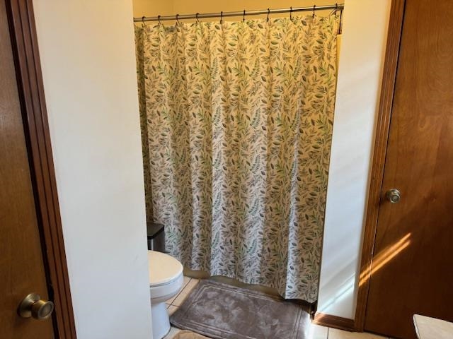 525 Middleton Loop Bolivar, TN 38008 - Photo 12 of 13 a white toilet sitting next to a shower curtain